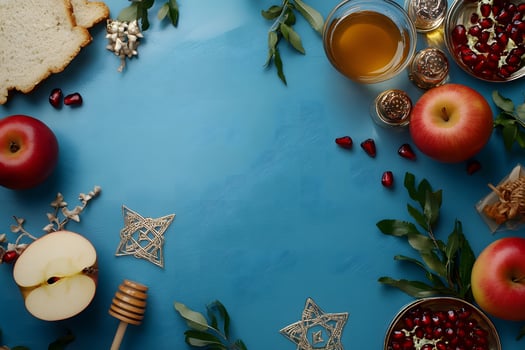 Overhead view shows Rosh Hashanah symbolic foods arranged over a blue surface, ready for eating photo