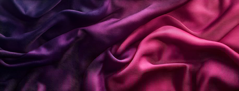 Purple and pink silk fabric drapes softly with a luxurious texture and vivid color photo