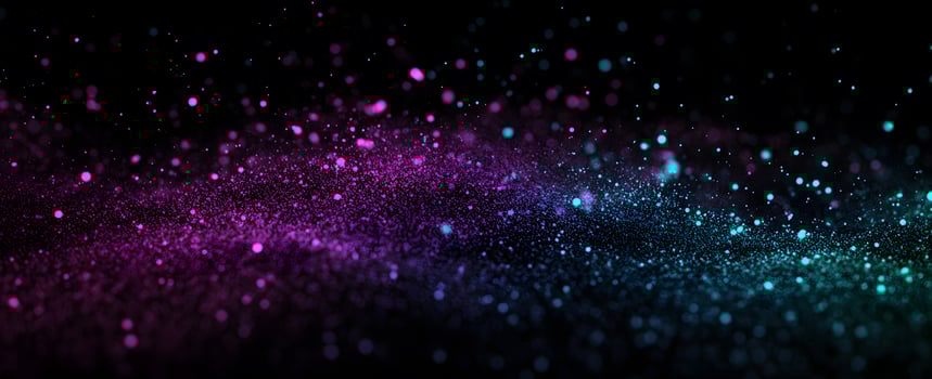 Shimmering pink and turquoise particles elegantly float and subtly dance against a black background photo