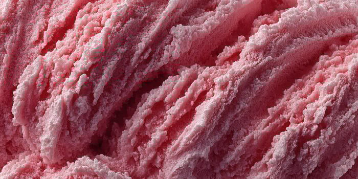 Soft pink cotton candy being spun at a fairground during a summer evening festival photo