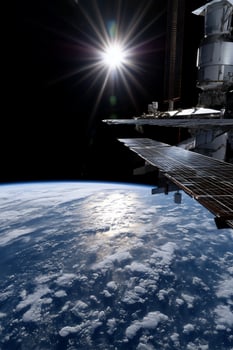 The sun shines over the earth from space photo