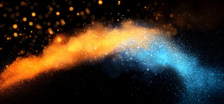 Sparkling golden and blue particles collide elegantly against the dark backdrop, creating an ethereal effect photo