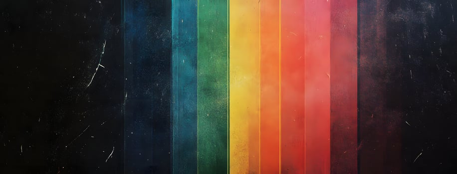 Vertical stripes of vibrant rainbow colors contrast with distressed, grainy, black background creating interest photo