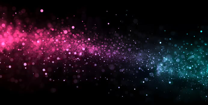 Vibrant pink and blue specks gently fade into the dark backdrop, creating magic photo