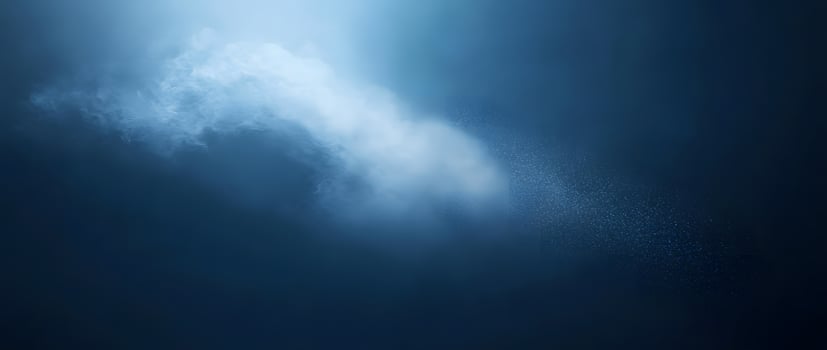 Wispy clouds meet raindappled surface, casting a tranquil blue glow throughout the entire frame photo