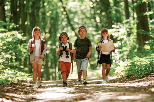 Conception of hiking.. Kids in forest at summer daytime together photo