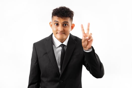 Handsome young black man wearing business suit and tie smiling with happy face winking at the camera doing victory sign. number two. photo