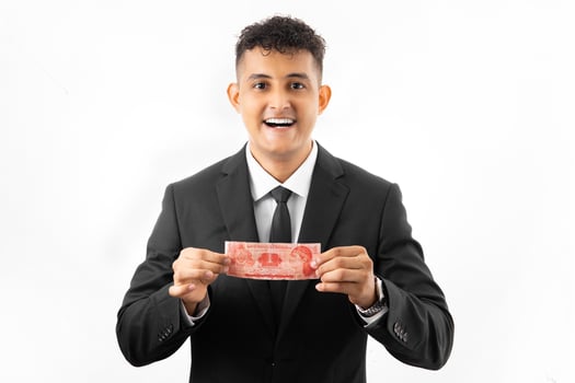 Honduran man wearing a business suit holding a Honduran banknote called lempira on an isolated white colored background. Economy concept. photo