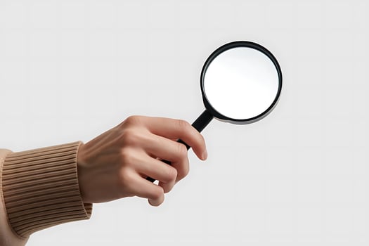Close-up of hand holding magnifying glass for investigation or search concept photo