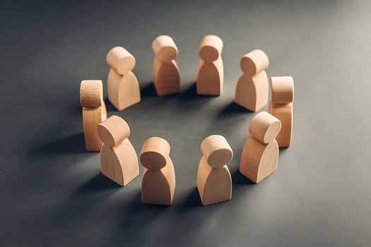 Wooden Figures Standing in Circle Symbolizing Teamwork and Unity photo