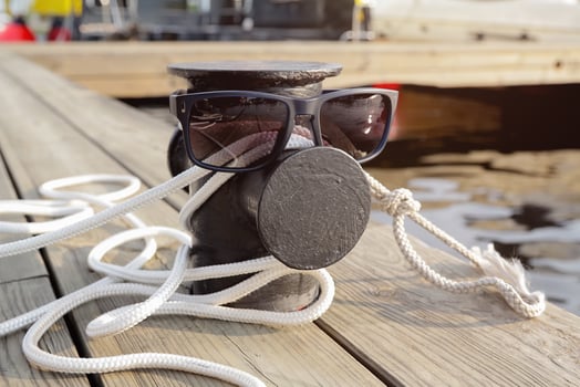 Mooring rope on the pier and sunglasses. Life style photo