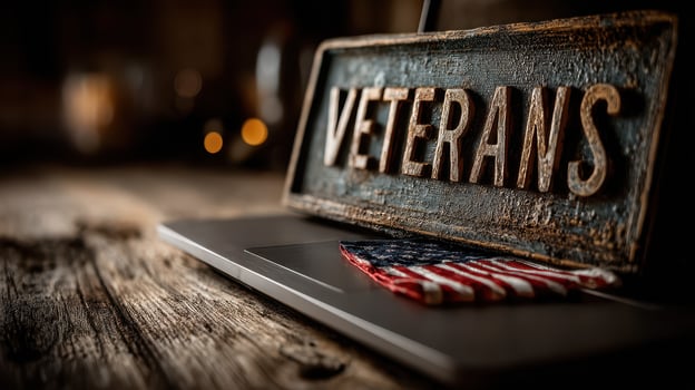 Sign honoring veterans placed on a rustic wooden table beside an American flag during a dimly lit setting photo