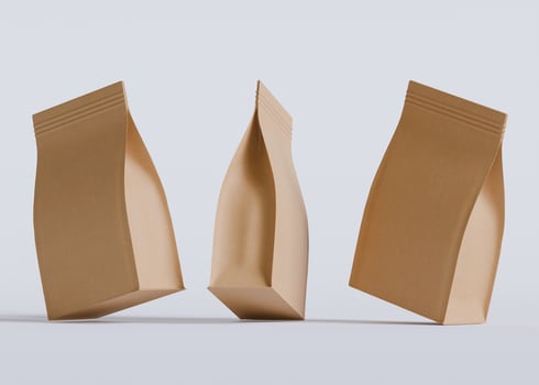 Three brown bags dynamic display white background photo