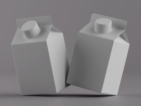 Two milk cartons on a gray background photo
