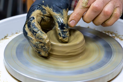 Wheel Throwing Close Up Molding Clay into a Bowl photo