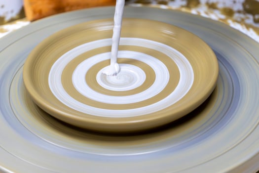 Pottery making, Paint brush glazing clay cup photo
