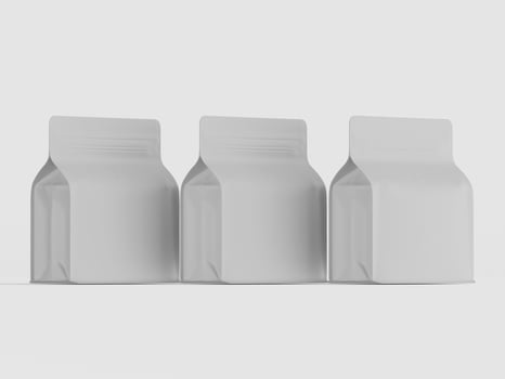 Three empty white plastic bags on a white surface photo