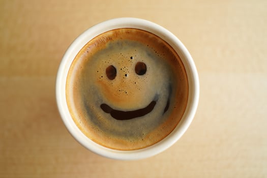 Coffee Background Happy Coffee Face Smiling Espresso in Disposable Cup on Wooden Table photo