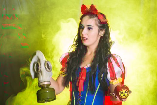 Woman in fairy tale dress holding hazardous radioactive apple. Nuclear and radiation measurement concept. photo