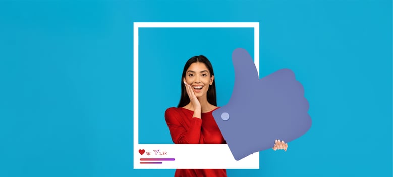 A young person expresses joy with a surprised expression while holding a large thumbs up symbol. The bright blue backdrop enhances the energetic vibe of this social media engagement moment. photo
