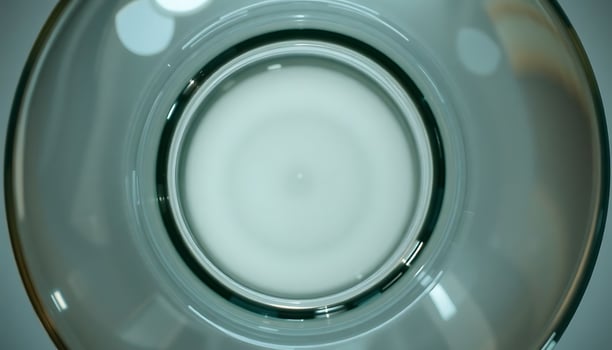 close up of a glass with a liquid inside of it photo