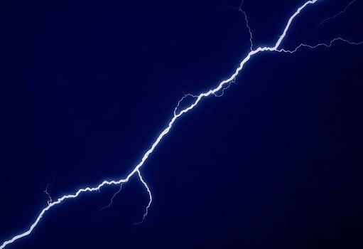 Lightning bolt on a dark blue sky photo