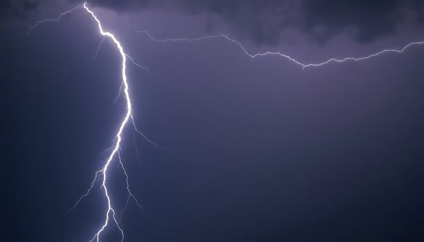 Lightning strike on dark sky background photo
