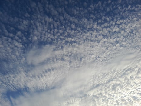 A beautiful sky filled with textured altocumulus clouds creating a soft and intricate pattern. photo
