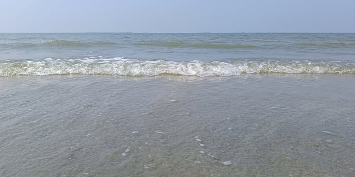 Calm sea water wave motion. Sky and waves on beach, background tourist attractions, relaxation photo