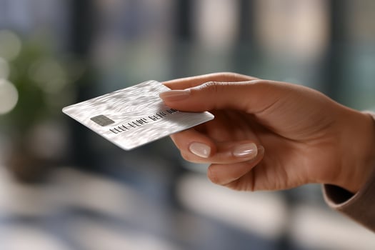 Close-up of a hand holding a silver credit card photo