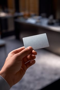 Hand holding blank business card photo