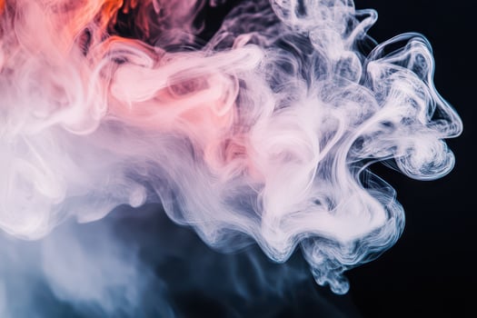 Colorful smoke swirling in the dark background photo