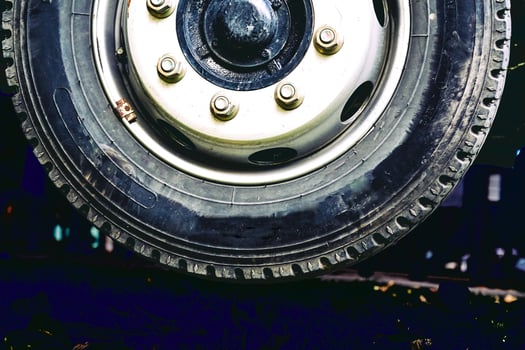 Wheel of a truck hangs in the air in night photo