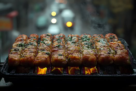 Grilled Meat Skewers on Smoky Barbecue Grill in Urban Setting photo