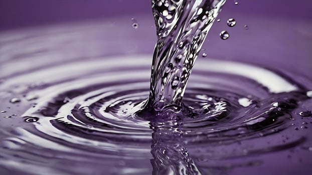 Elegant Flow of Purple Liquid Creates Mesmerizing Circular Ripples photo