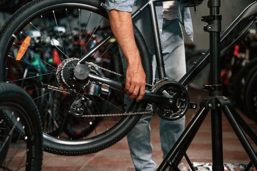 Close up view of man's hands that is repairing bicycle,, photo