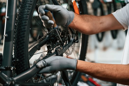 Fixing the derailleur.... Close, up ,view of man's hands that is repairing bicycle photo