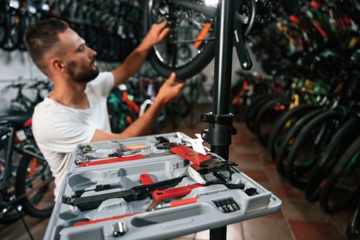 Bunch of tools. Repair ,man,, in bicycle shop, working in store photo