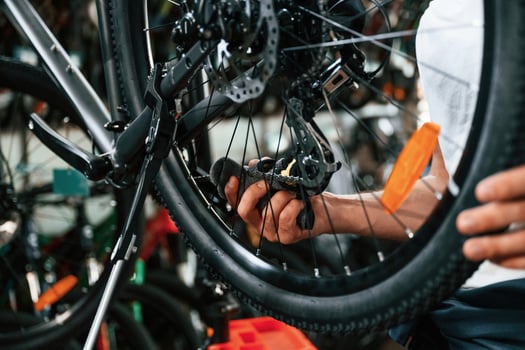 Close up view of man's, hands that is repairing bicycle photo