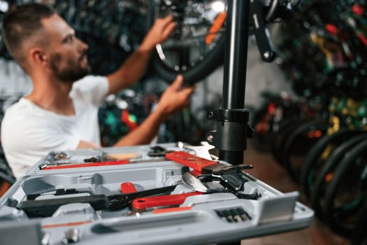Bunch, of tools. Repair man in bicycle shop, working in store photo