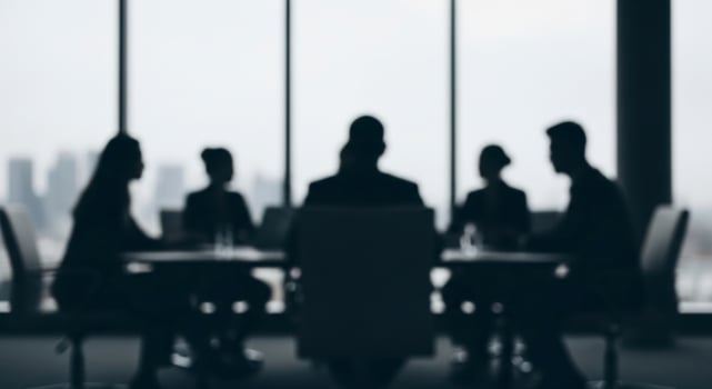 Blurred Silhouettes of Business People in a Corporate Meeting Room with City Skyline View photo