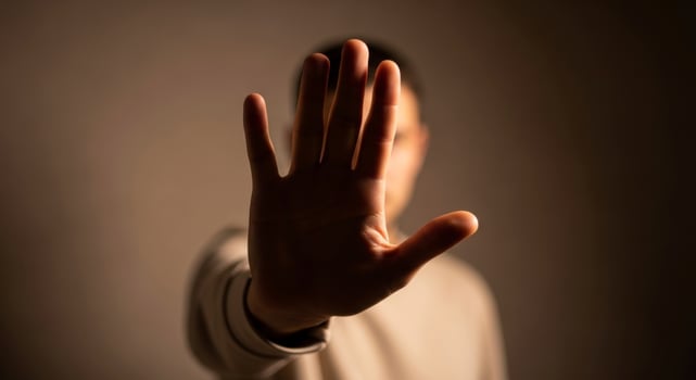 Human hand held up with palm facing forward, signaling stop, refusal, and boundary. photo