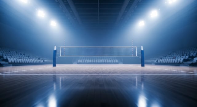 Empty indoor volleyball court with net, polished floor, and stadium seating under bright lights photo