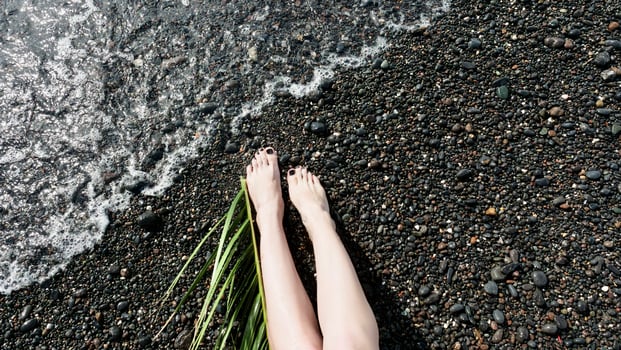 A woman's legs on the beach with grass photo