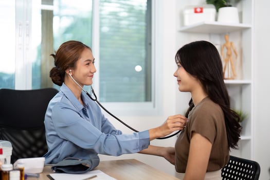 Doctor-Patient Interaction. Healthcare professional using stethoscope for patient examination. photo