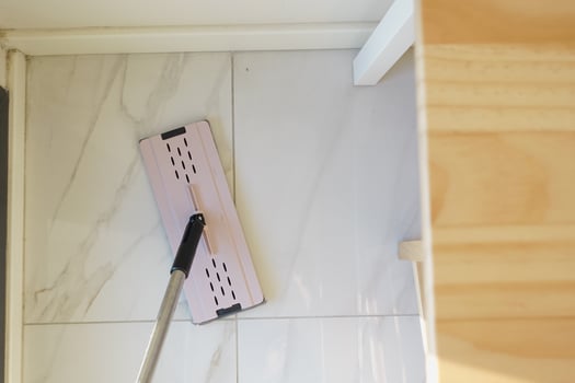 Cleaning the floor with a mop during home maintenance photo