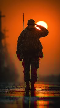 Soldier saluting at sunset in a tranquil landscape symbolizing honor and sacrifice photo