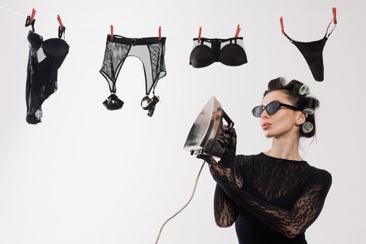 Woman ironing lingerie on clothesline photo