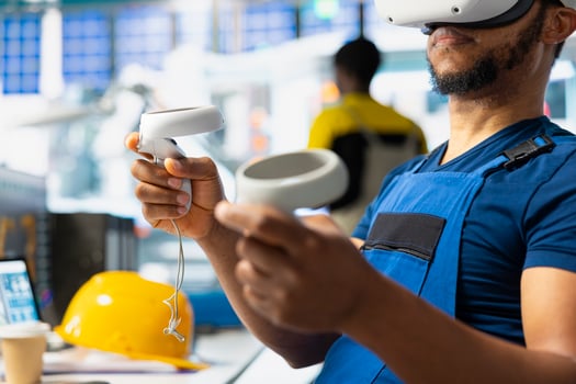 Black industrial factory employee using virtual reality gear to oversee system performance. Solar panels manufacturing plant technician employs VR glasses to track energy production. photo