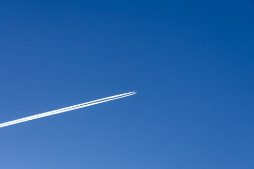 supersonic high in the blue sky leaves a trail behind photo